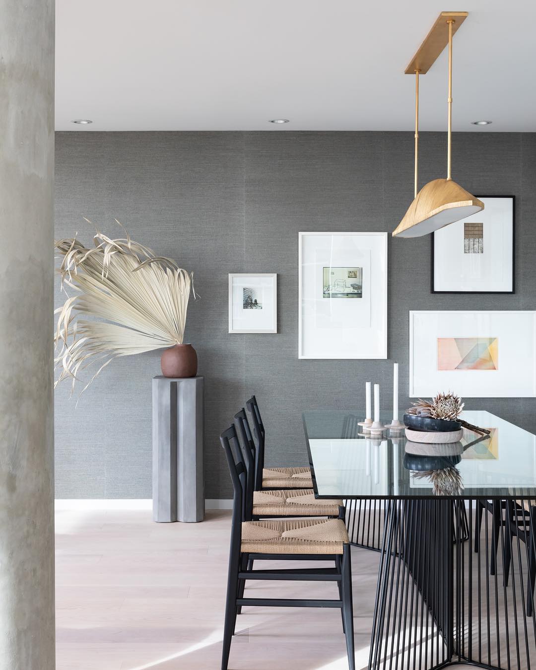 Modernly designed dining area with gray paint and gallery wall